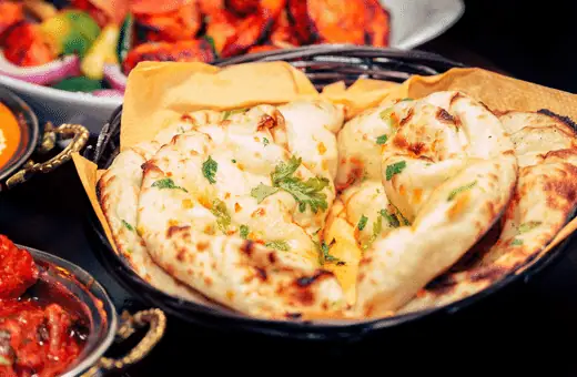 Naan goes well with biryani because it soaks up all the delicious flavors of the dish and helps balance out its spiciness