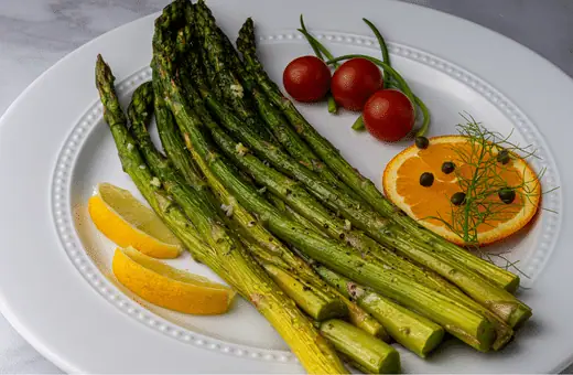 Roasted asparagus is an evergreen side dish because it is a simple yet flavorful vegetable that pairs well with coconut shrimp. Simply toss asparagus spears with olive oil, salt, and pepper, then roast in the oven until tender.