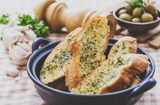 Garlic bread is a classic side dish that pairs well with various main courses. When served with honey garlic chicken, the bread helps to soak up the excess sauce and provides a delicious contrast to the tender, cooked chicken. 