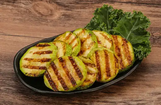 Grilled zucchini slices add a smoky flavor to any meal, especially when served with coconut shrimp. 