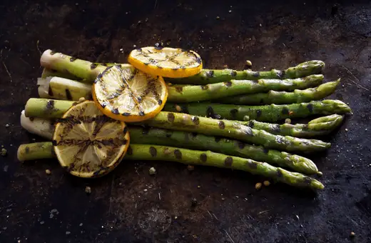 Asparagus spears are grilled with olive oil and coarse sea salt. Serve hot from the grill while they're still crisp but tender enough to slice easily when paired with succulent bird meat!