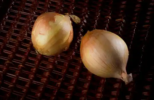 Onions are a key ingredient in most versions of this classic Filipino dish, lending a sweet, savory taste that pairs perfectly with adobo sauce's pungent flavor.