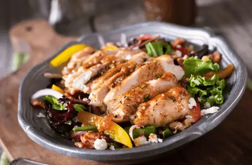 grilled chicken salad with fresh greens and vegetables is a perfect side dish to pair with gazpacho soup