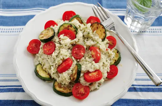 Insalata Di Riso, or Italian Rice Salad, is made with cooked Basmati rice, diced bell peppers, cucumbers, and salami. 