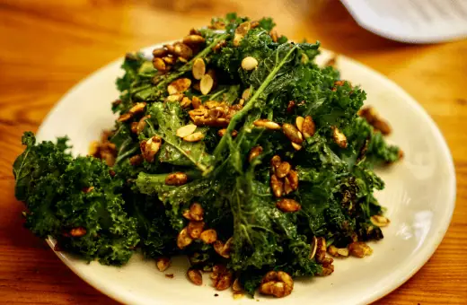 The tuscan kale salad is made with kale, roasted butternut squash, pecans, and dried cranberries, dressed with a lemon and olive oil vinaigrette. 
