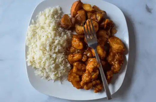 orange chicken and rice on a platter